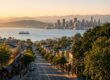 Golden-hour view down Lonsdale Avenue toward the harbour and downtown Vancouver skyline